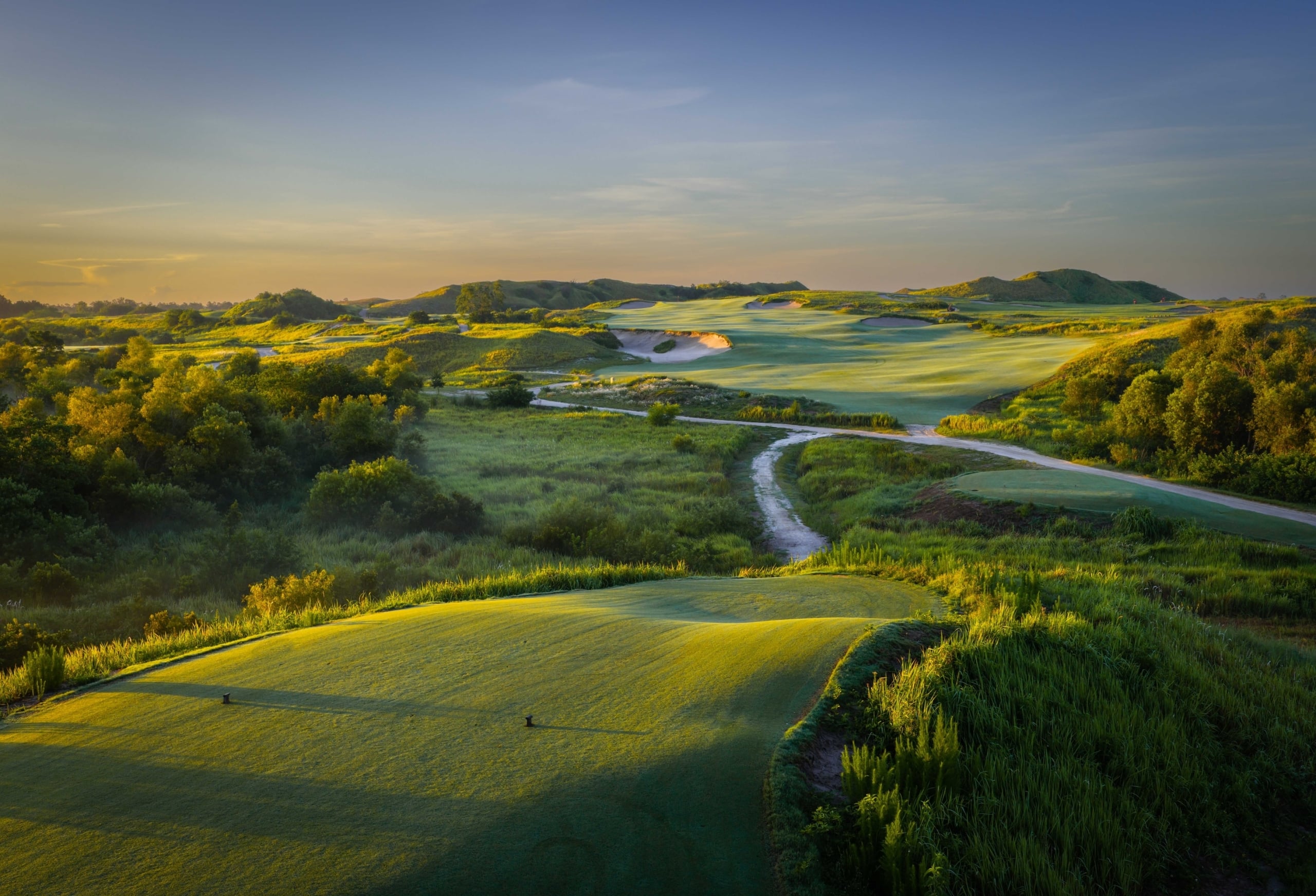 Aerial view of the 15th hole at Streamsong Red golf course, with a winding path between fairways