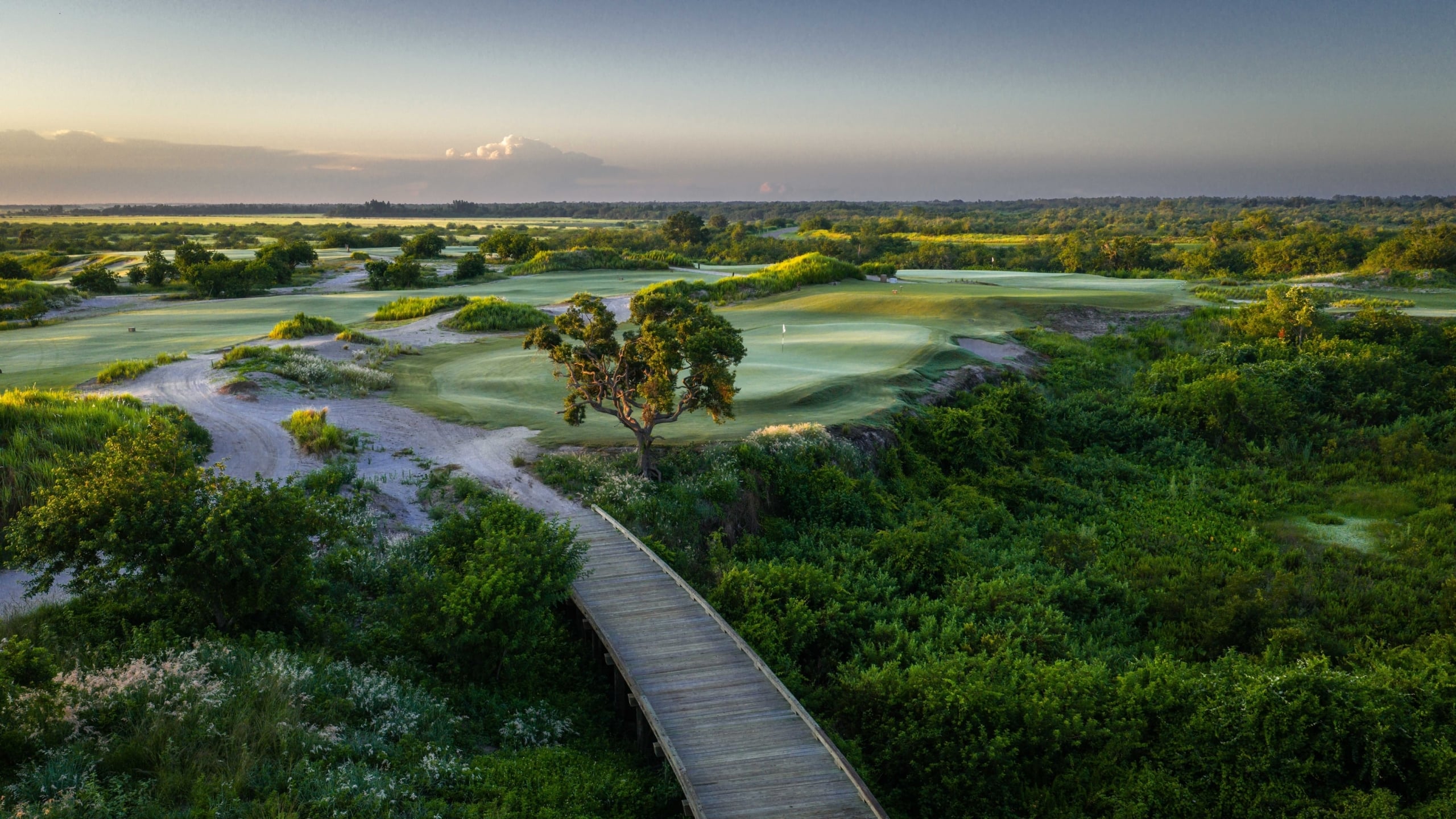 The 16th hole of the Chain golf course at Streamsong Resort, featuring a stone pathway around a treelined fairway