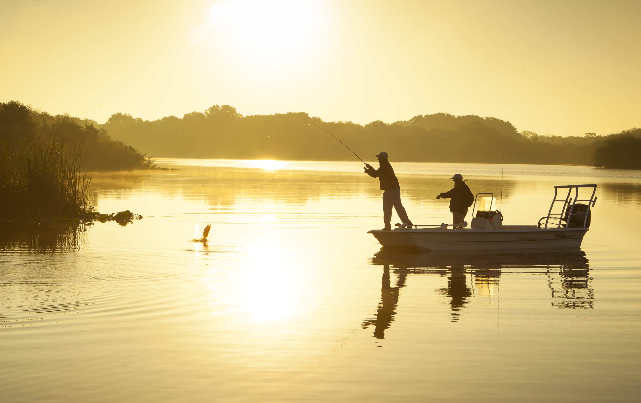 Fishing from boat at sunset/sunrise