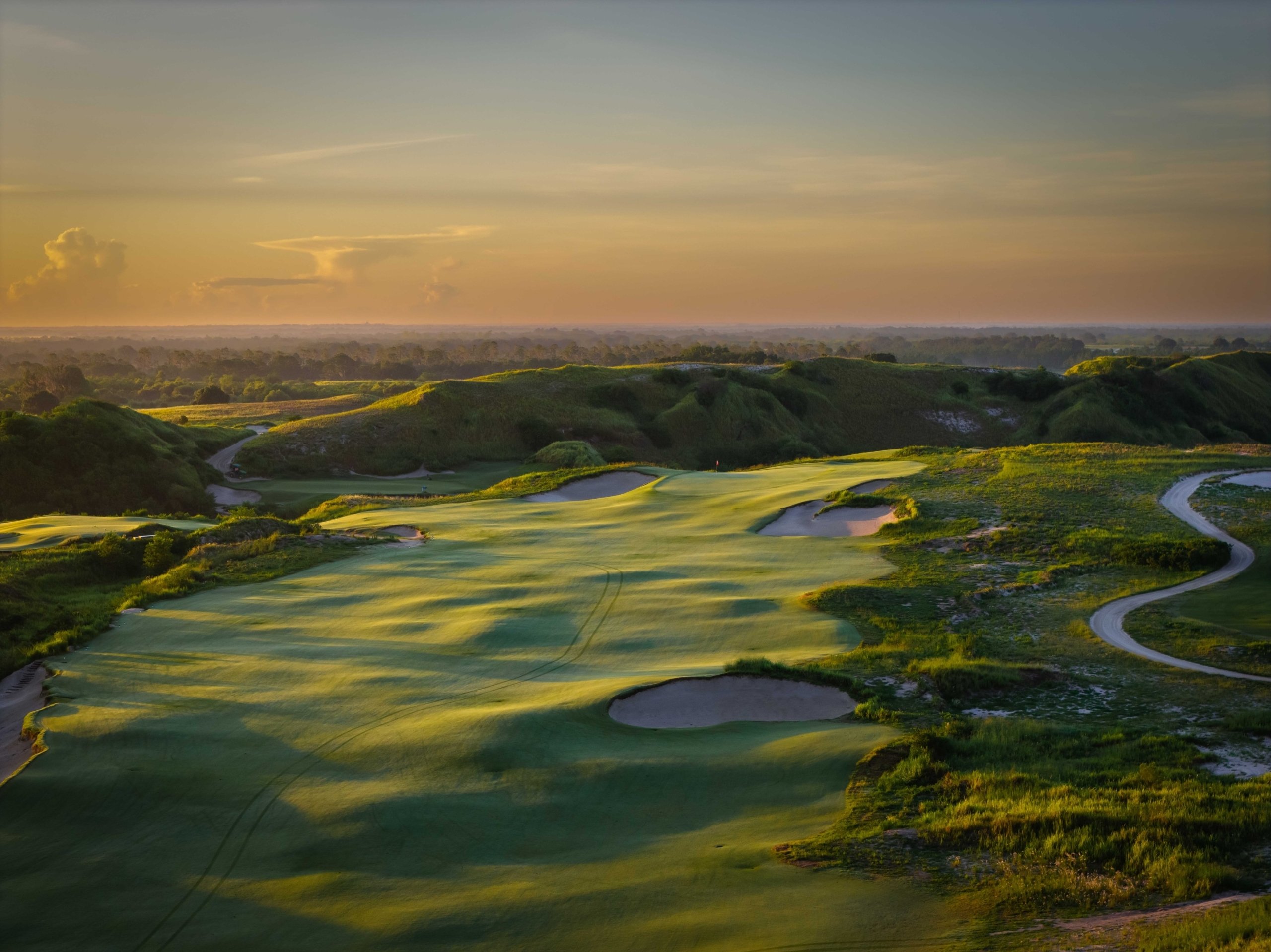 Aerial view of a broad fairway on Streamsong Red golf course, at dusk