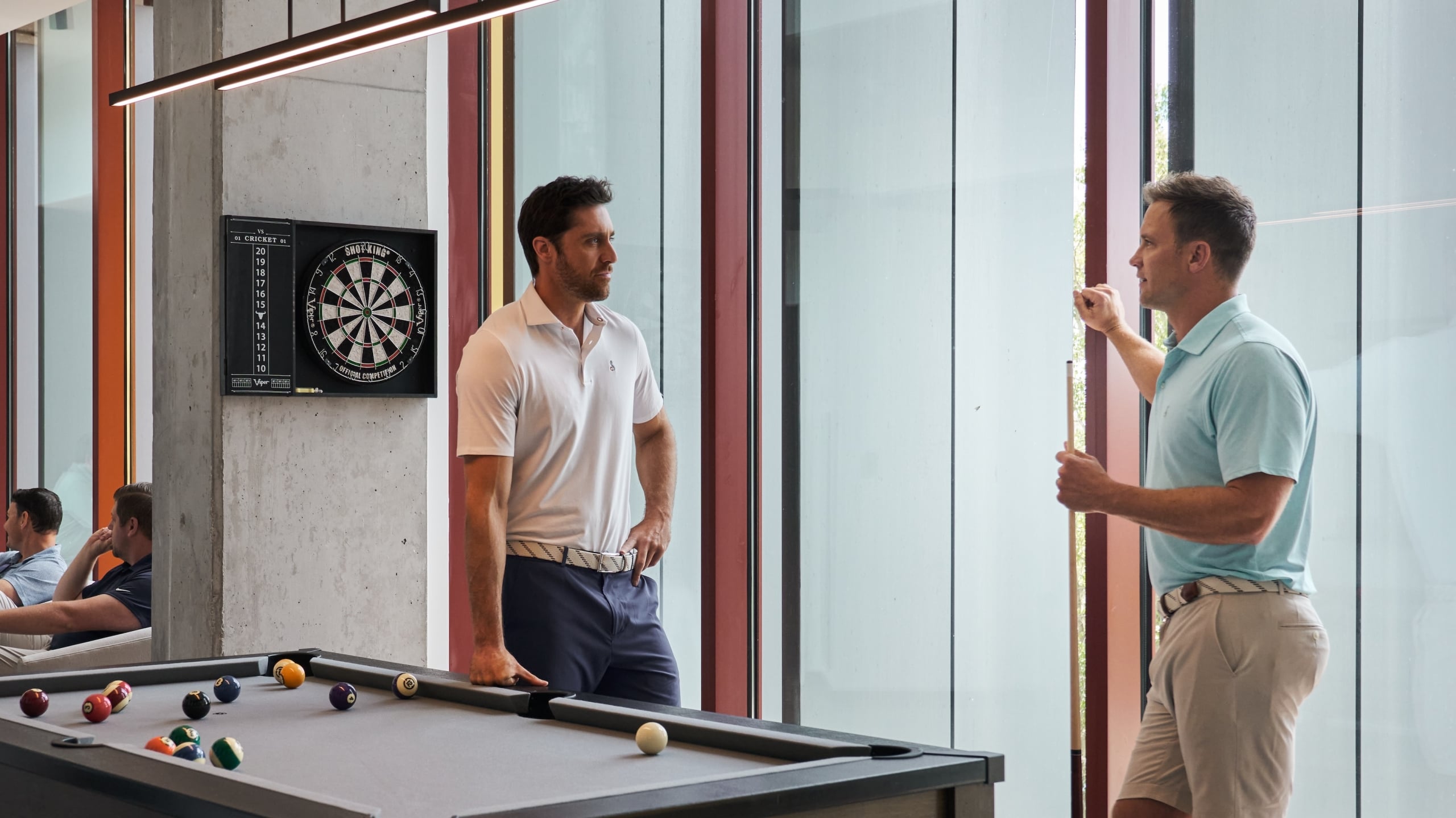 friends chatting by the pool table in the bunker wing