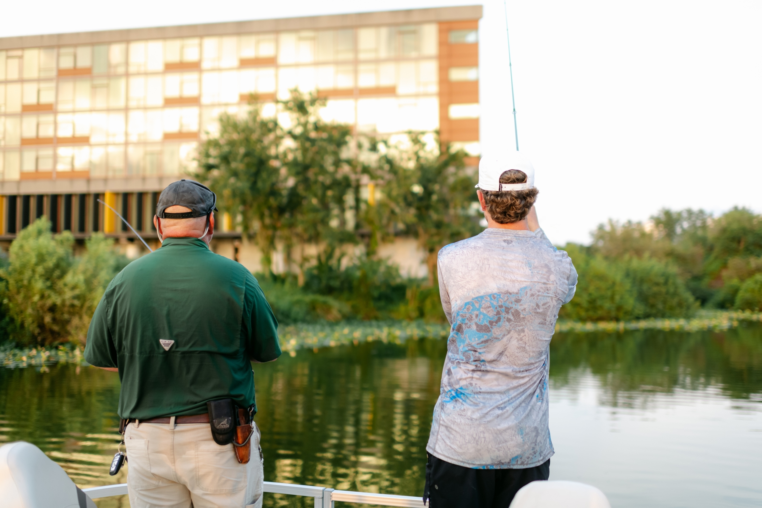 A man casts his line in view of the Streamsong lodge on a guided fishing tour