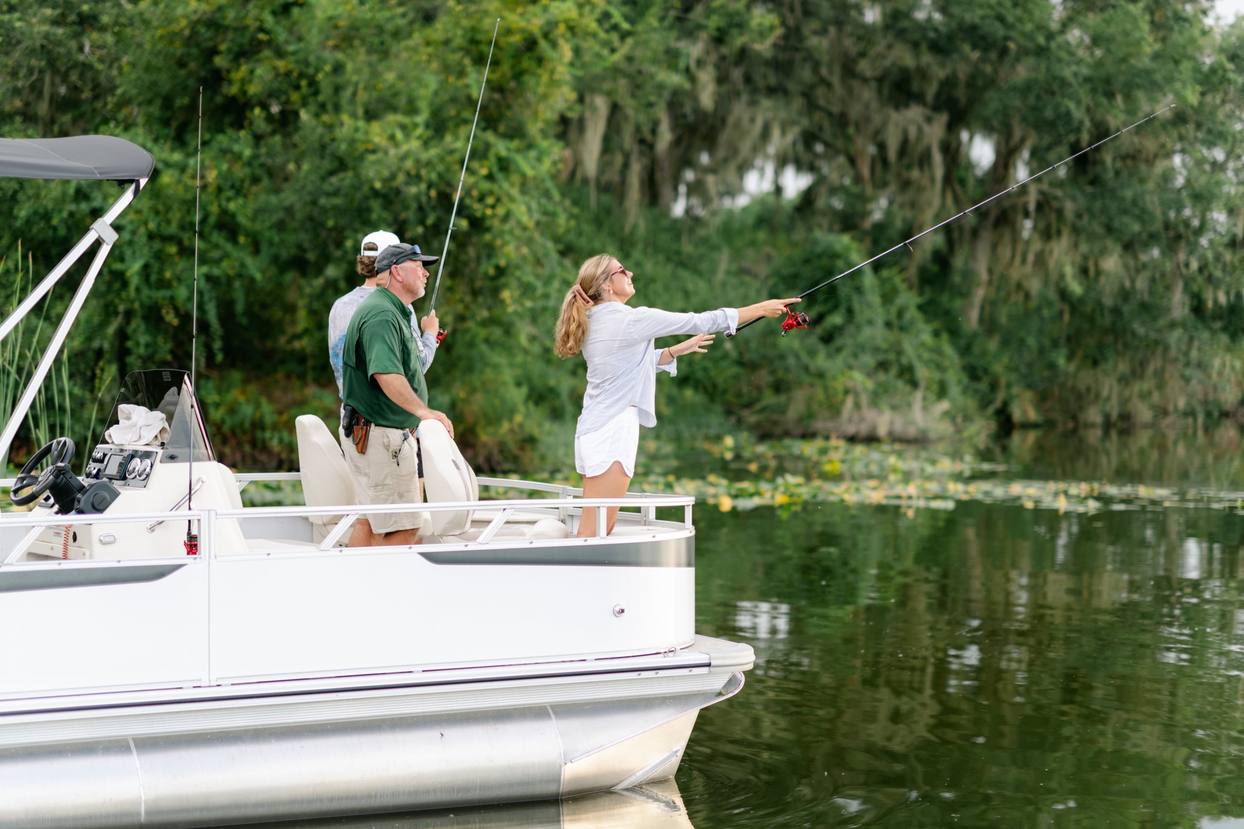 A woman casts her line on a guided fishing tour at Streamsong