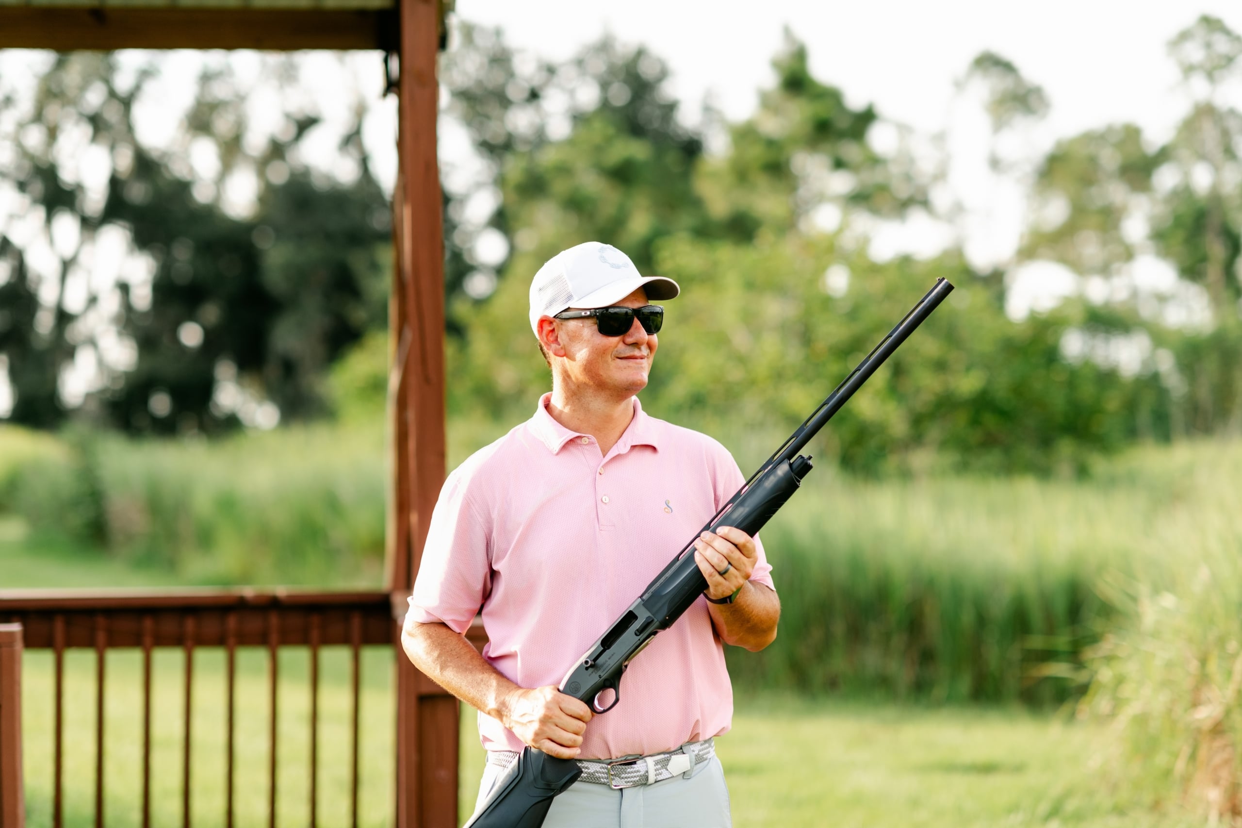 A man holding a rifle at a sporting clays demonstration at Streamsong